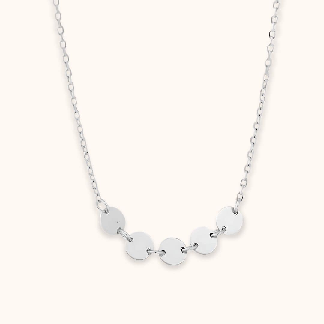 Silver mini disc necklace showcasing its modern and polished design, great for layering or wearing solo for a timeless look.